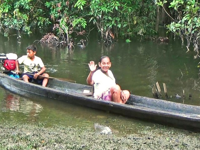 Community health worker (and her grandson) arrives at training session